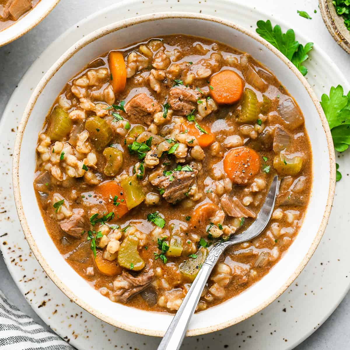 a bowl of Beef Barley Soup with a spoon