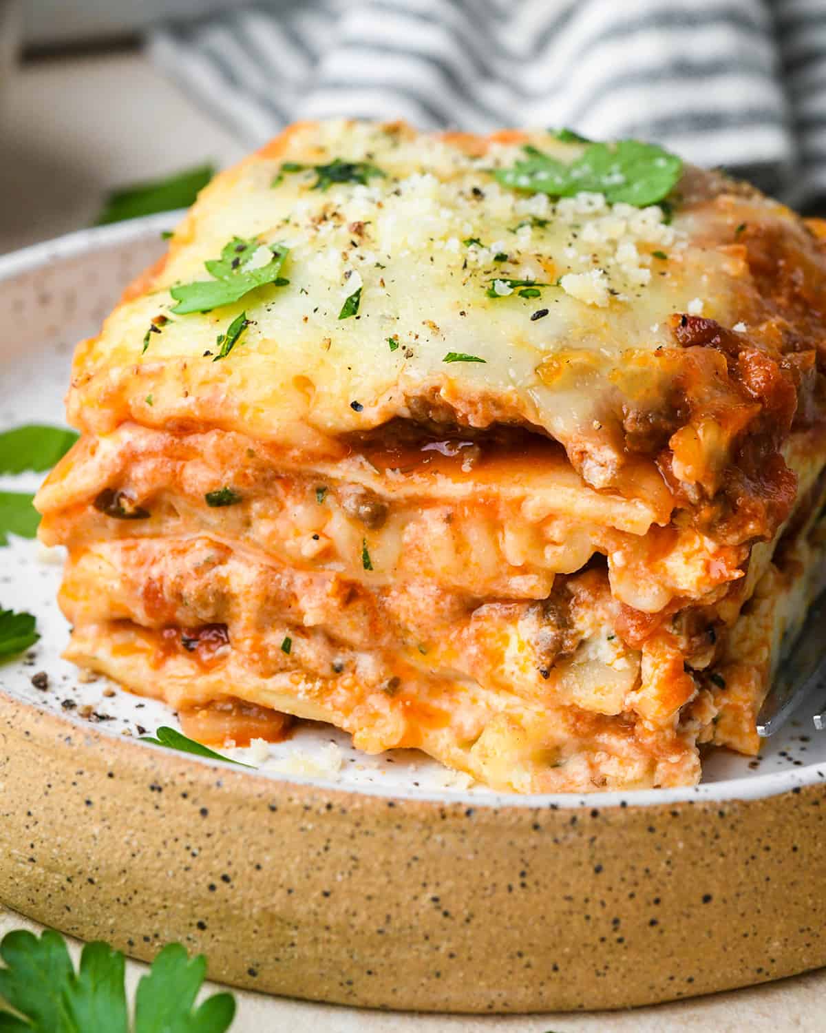 front view of a piece of beef lasagna on a plate