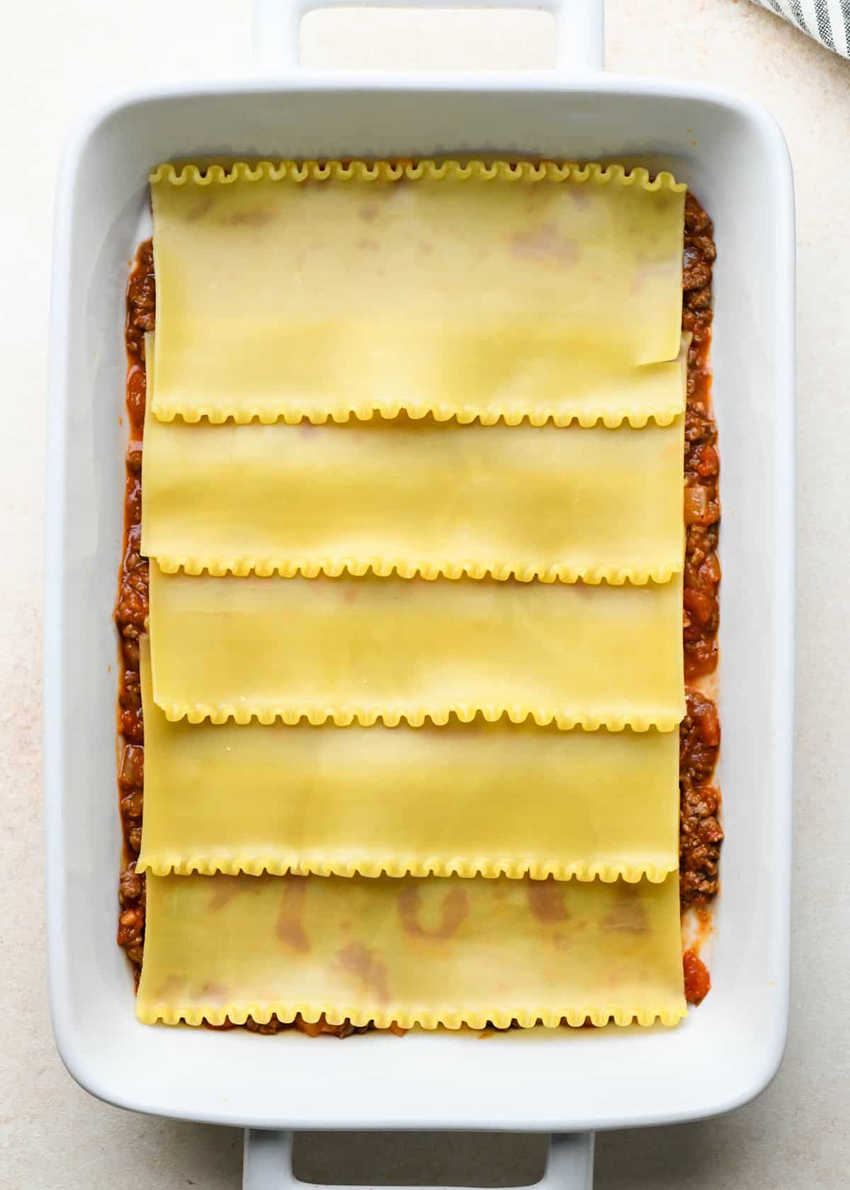 photo showing how to assemble beef lasagna - adding the noodles