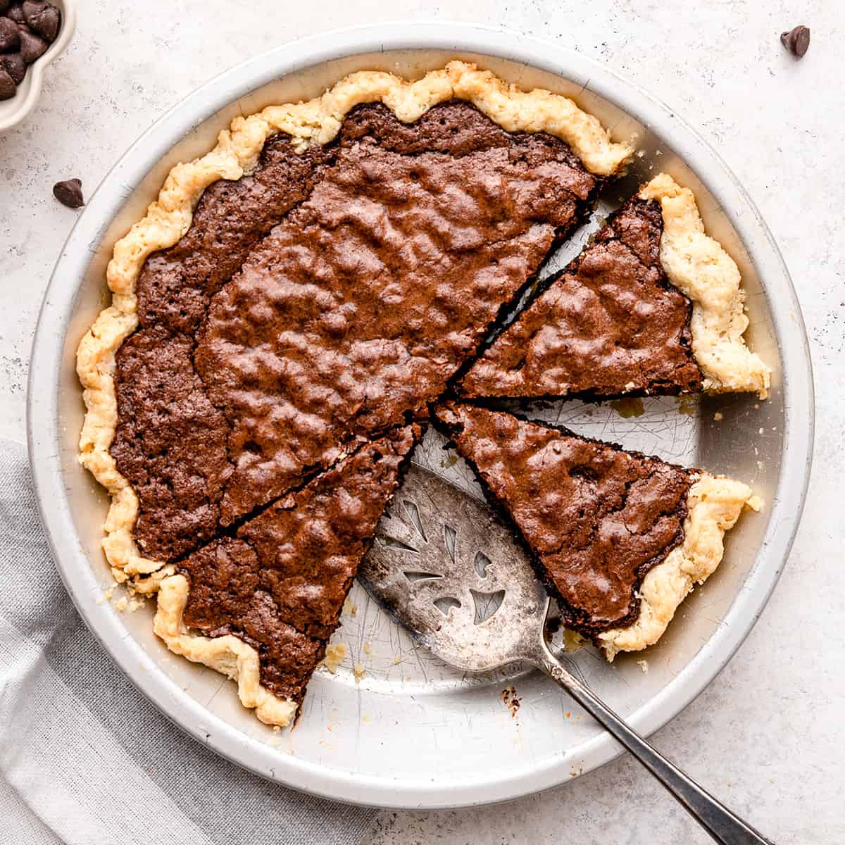 Brownie Pie in a pie dish with 3 slices cut out of it
