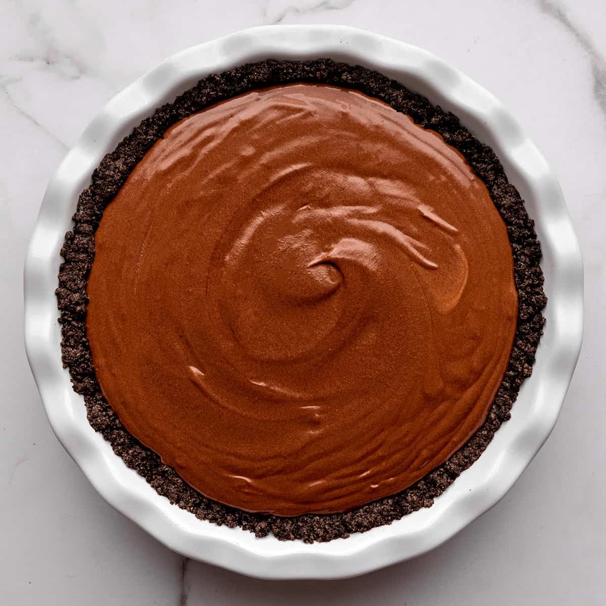 chocolate pudding pie filling spread into the oreo pie crust