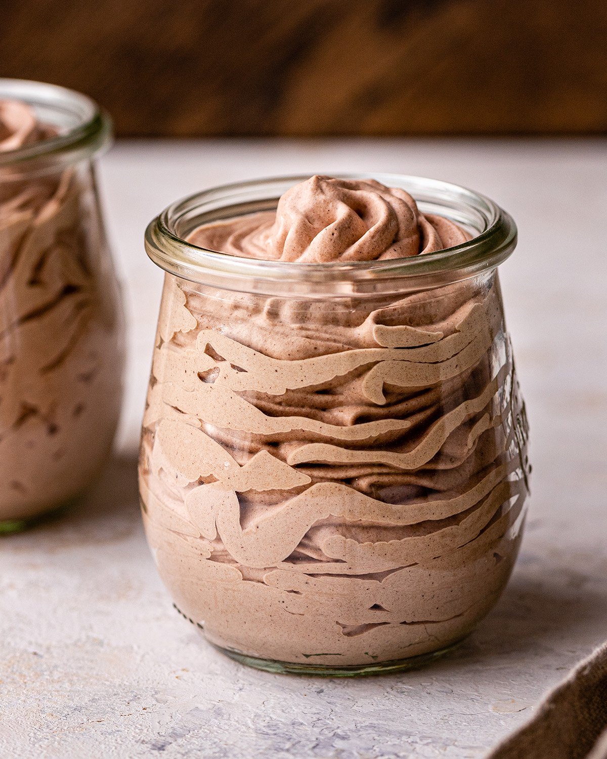 Chocolate Whipped Cream piped into a glass jar 