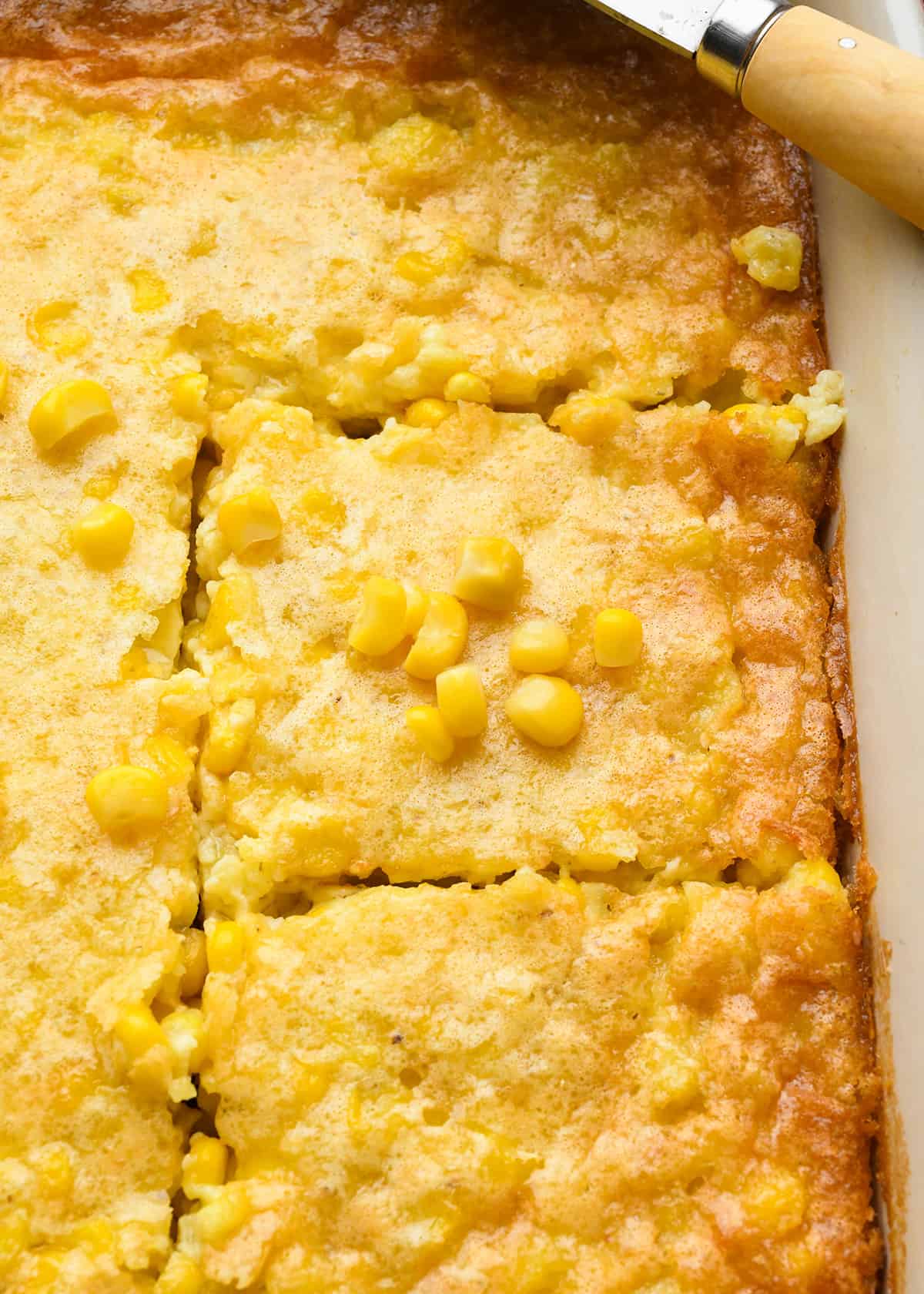 Corn Pudding in a baking dish cut into squares