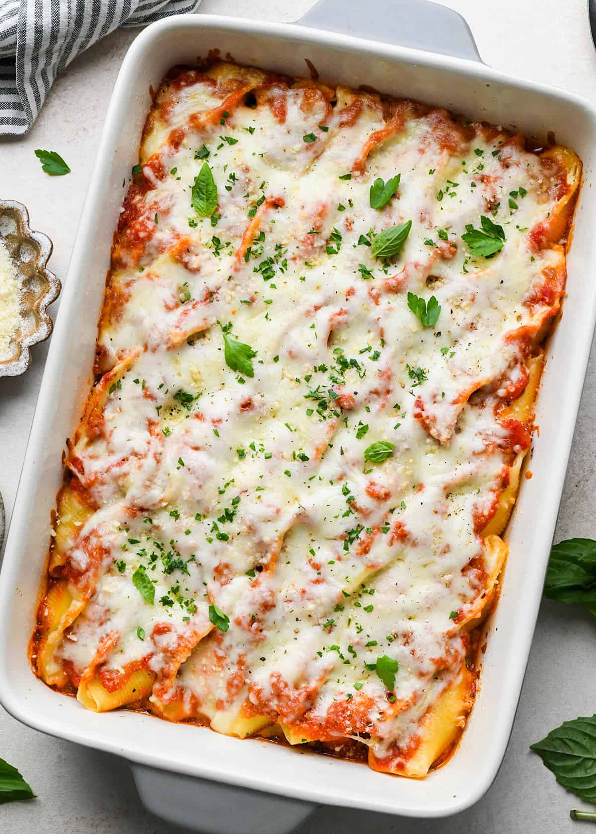 baked Stuffed Shells in a baking dish with parsley