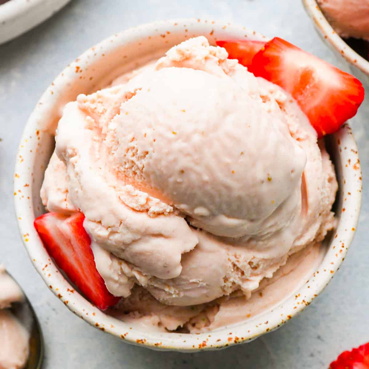 Strawberry Ice Cream in a bowl with fresh strawberries