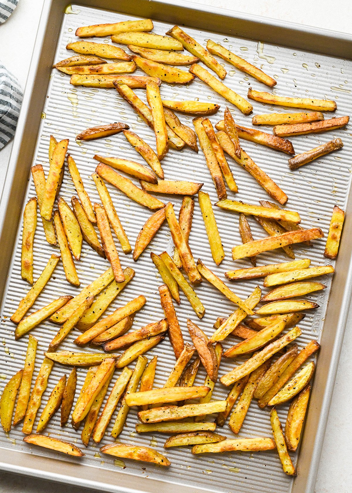 oven baked french fries on a baking sheet after baking