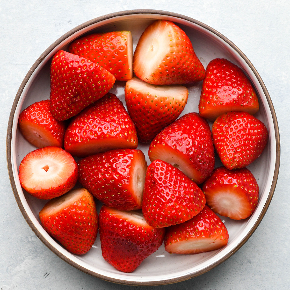 a bowl of trimmed strawberries