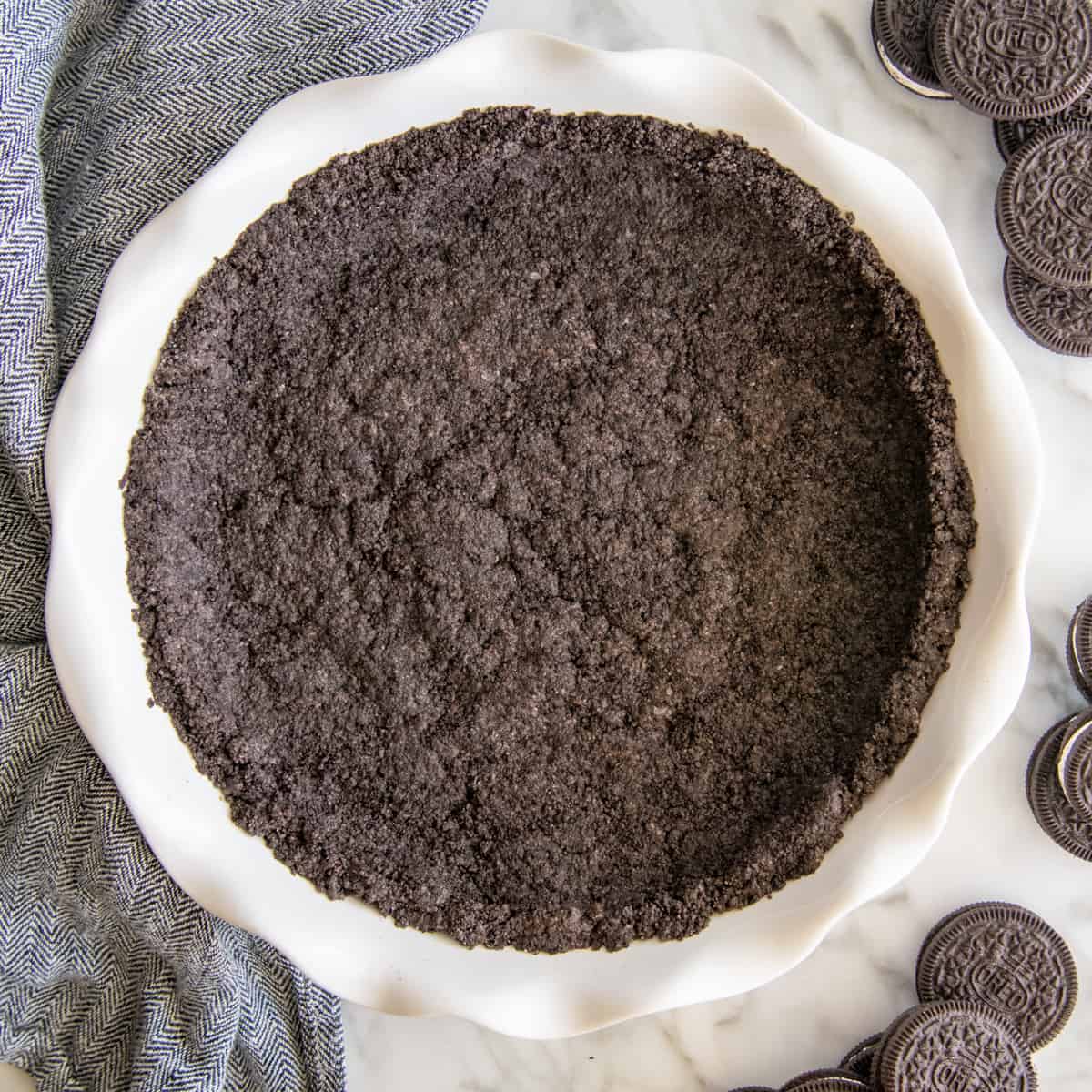 a baked Oreo Pie Crust in a white pie dish