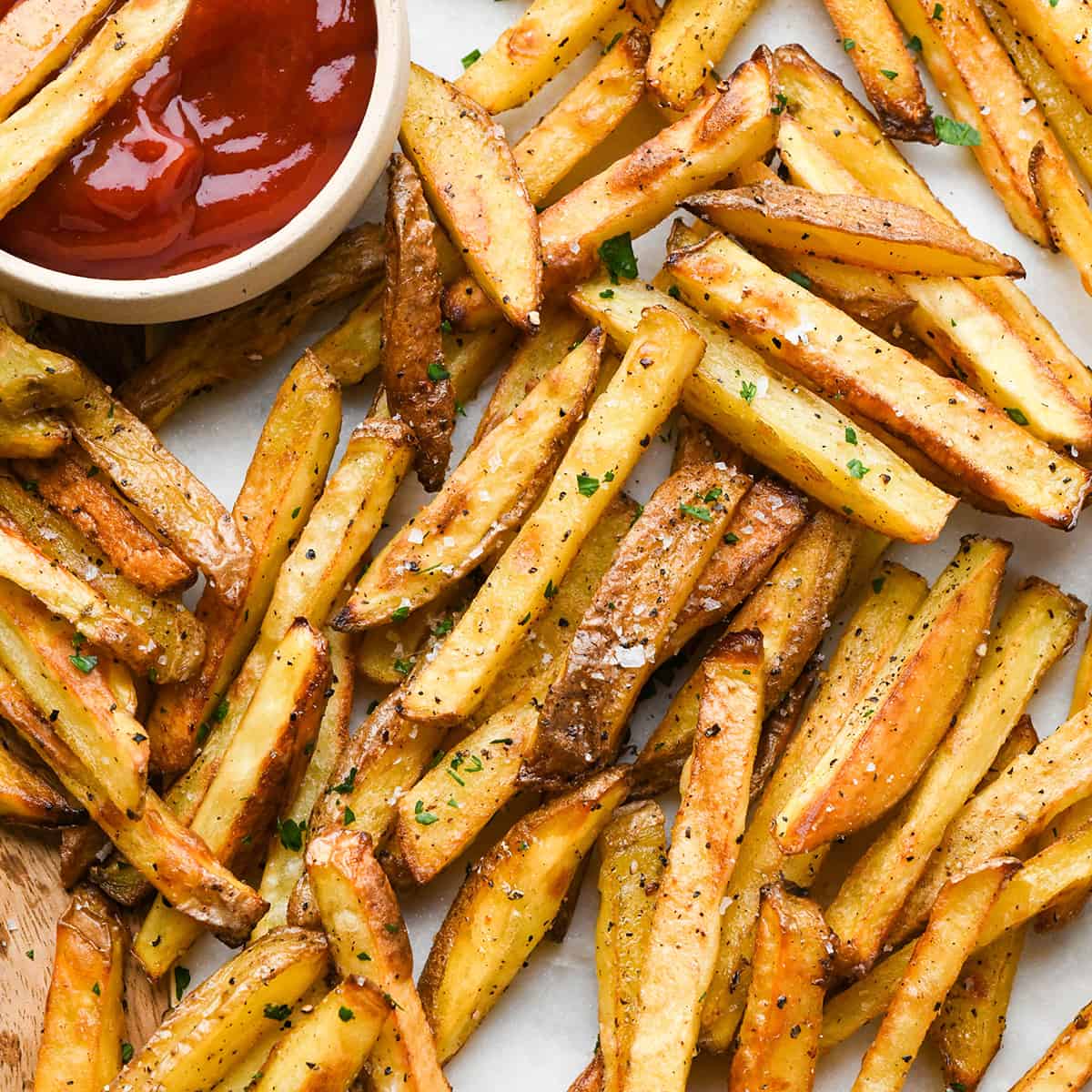 Homemade Baked French Fries on a plate with a bowl of ketchup