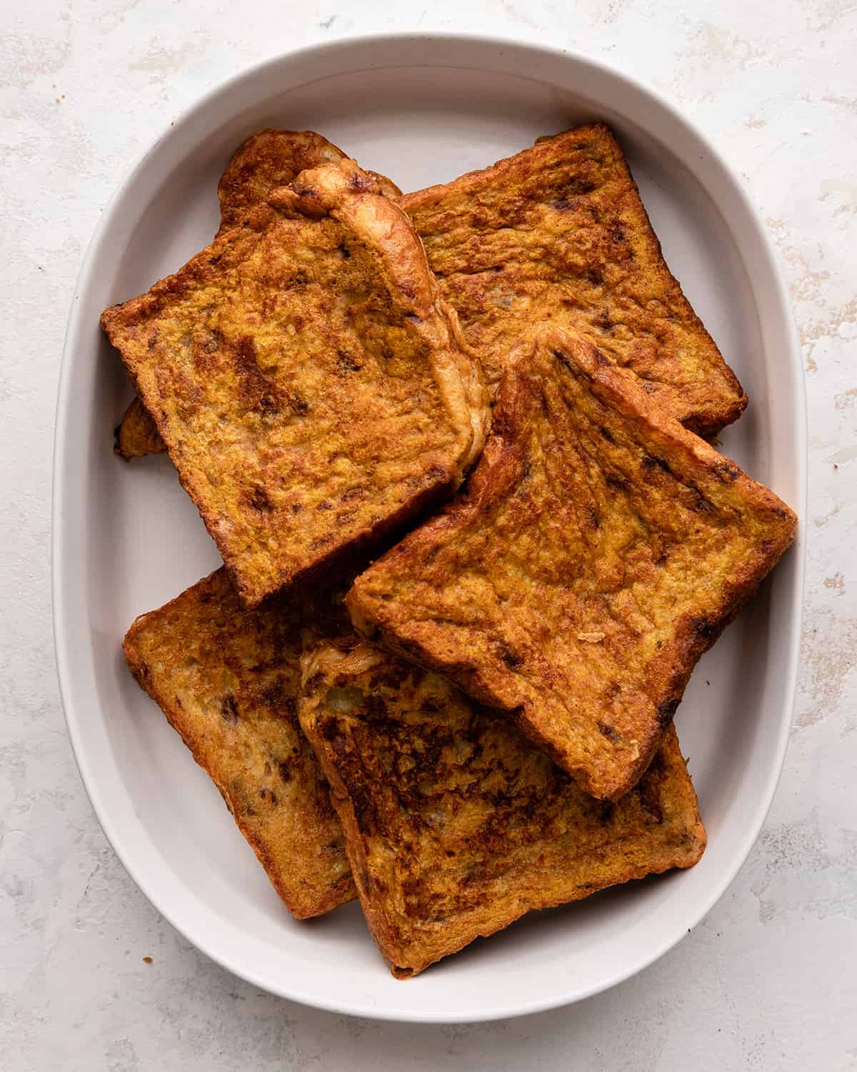 6 slices of Pumpkin French Toast in a baking dish to keep warm