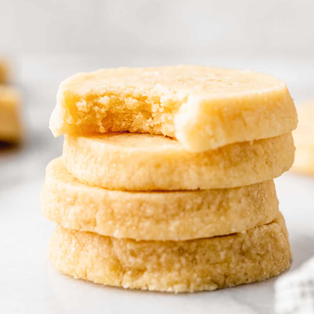 stack of 4 Shortbread Cookies, top one has a bite taken out of it