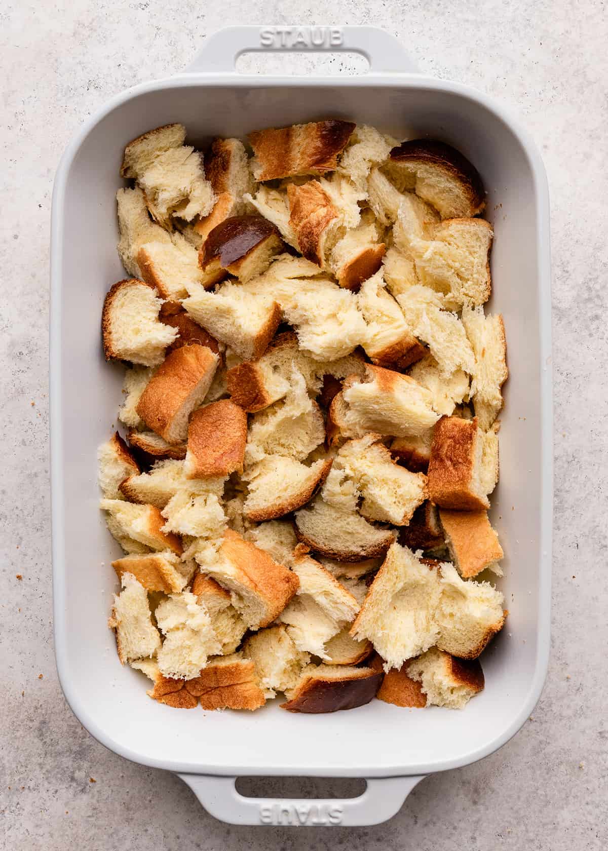 torn pieces of bread in a baking dish