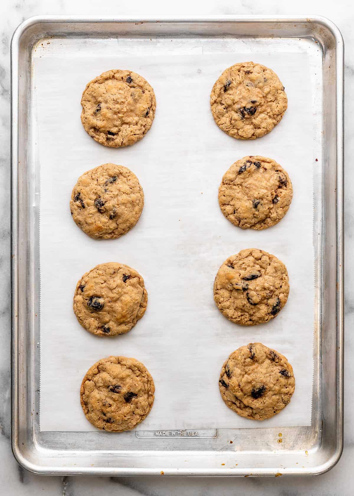 8 Oatmeal Raisin Cookies on a baking sheet
