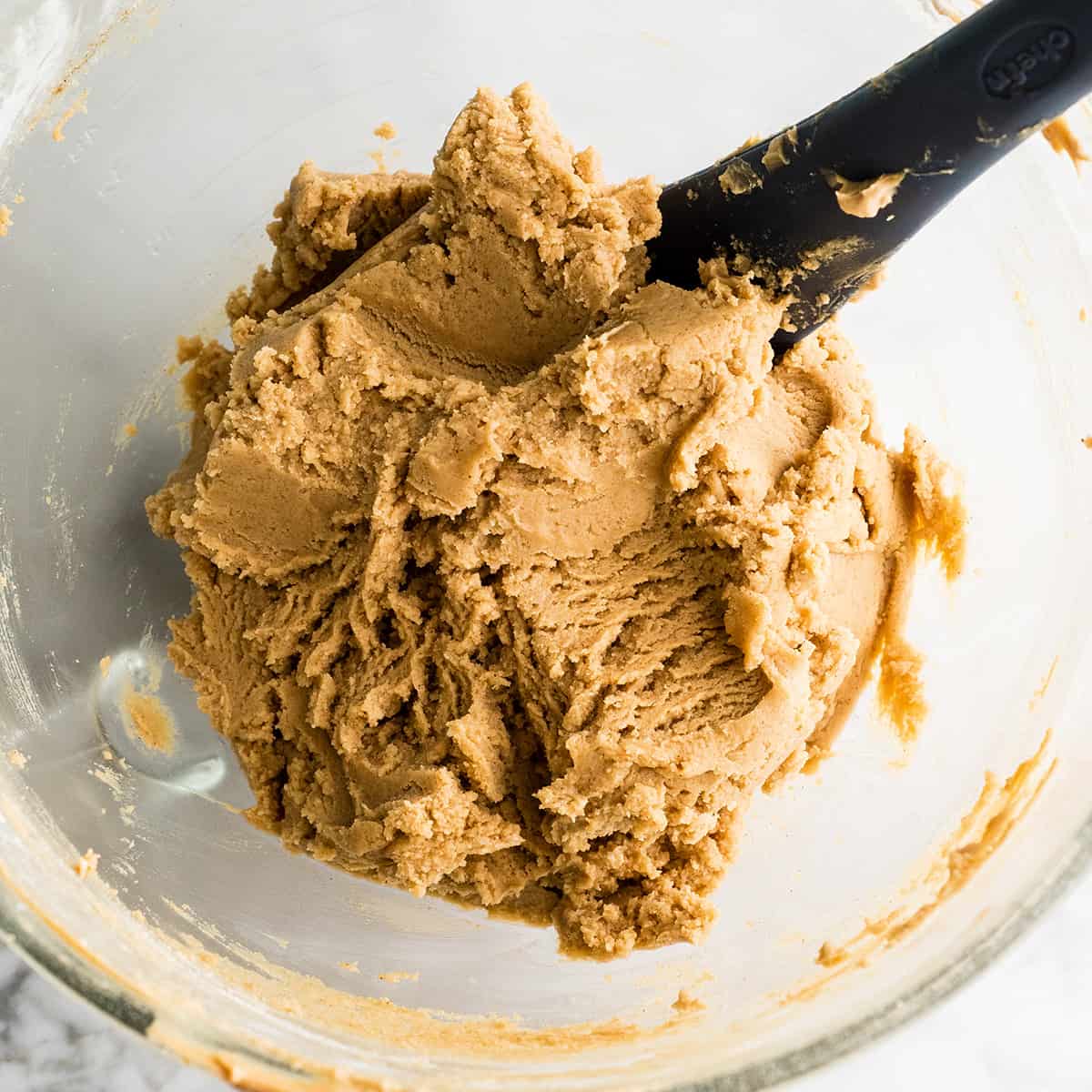 peanut butter cookie dough in a bowl with a spatula 