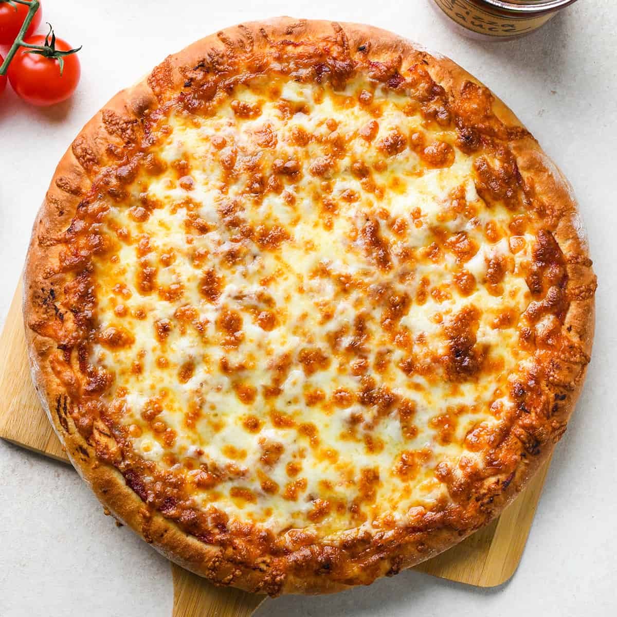 a round homemade Pizza on a pizza peel