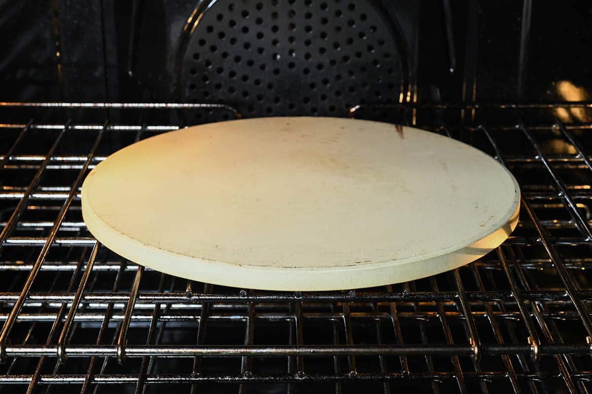 How to Make Pizza - a pizza stone preheating in an oven