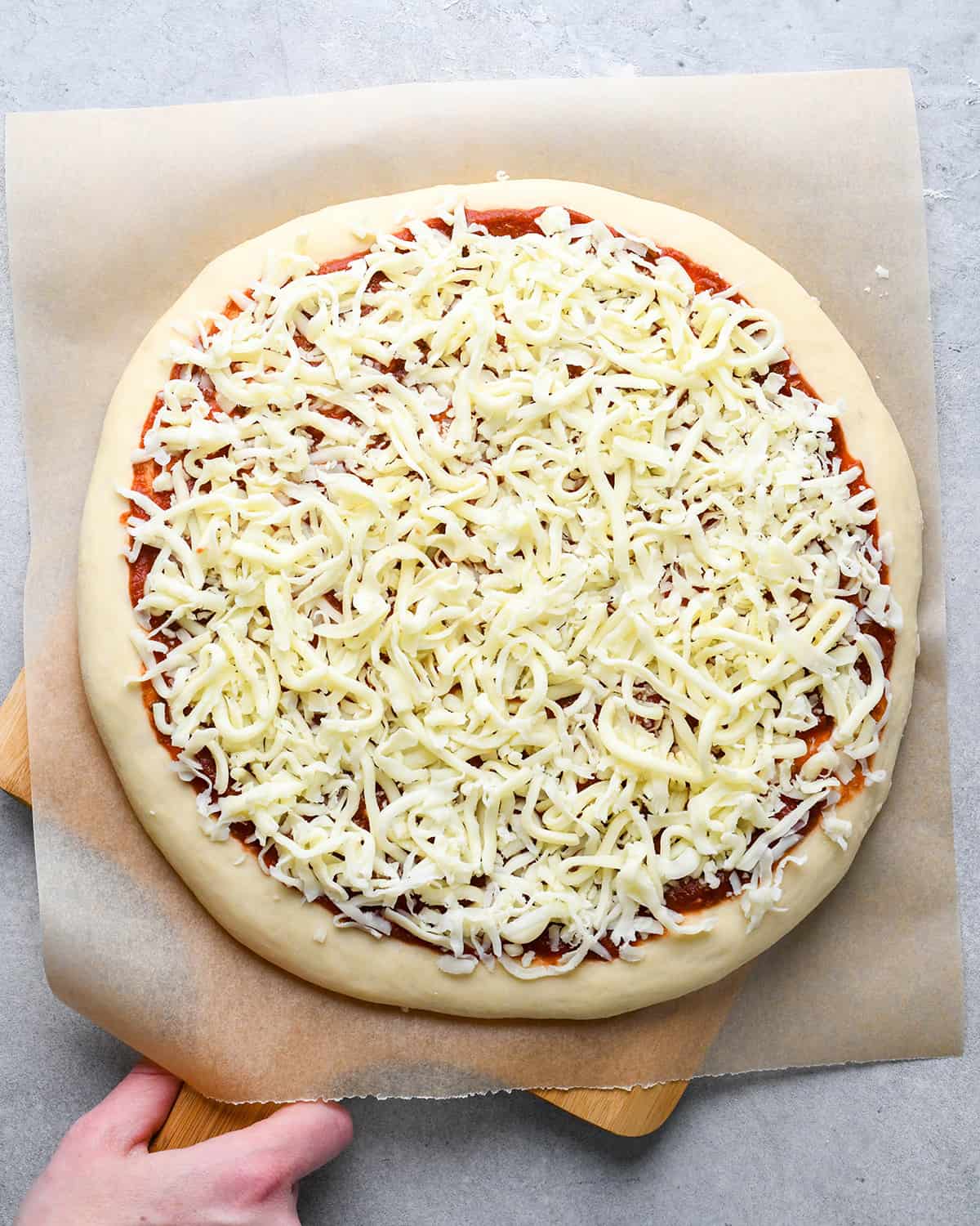 homemade pizza on a pizza peel before baking
