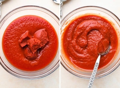 a spoon holding a scoop of pizza sauce over a bowl of pizza sauce