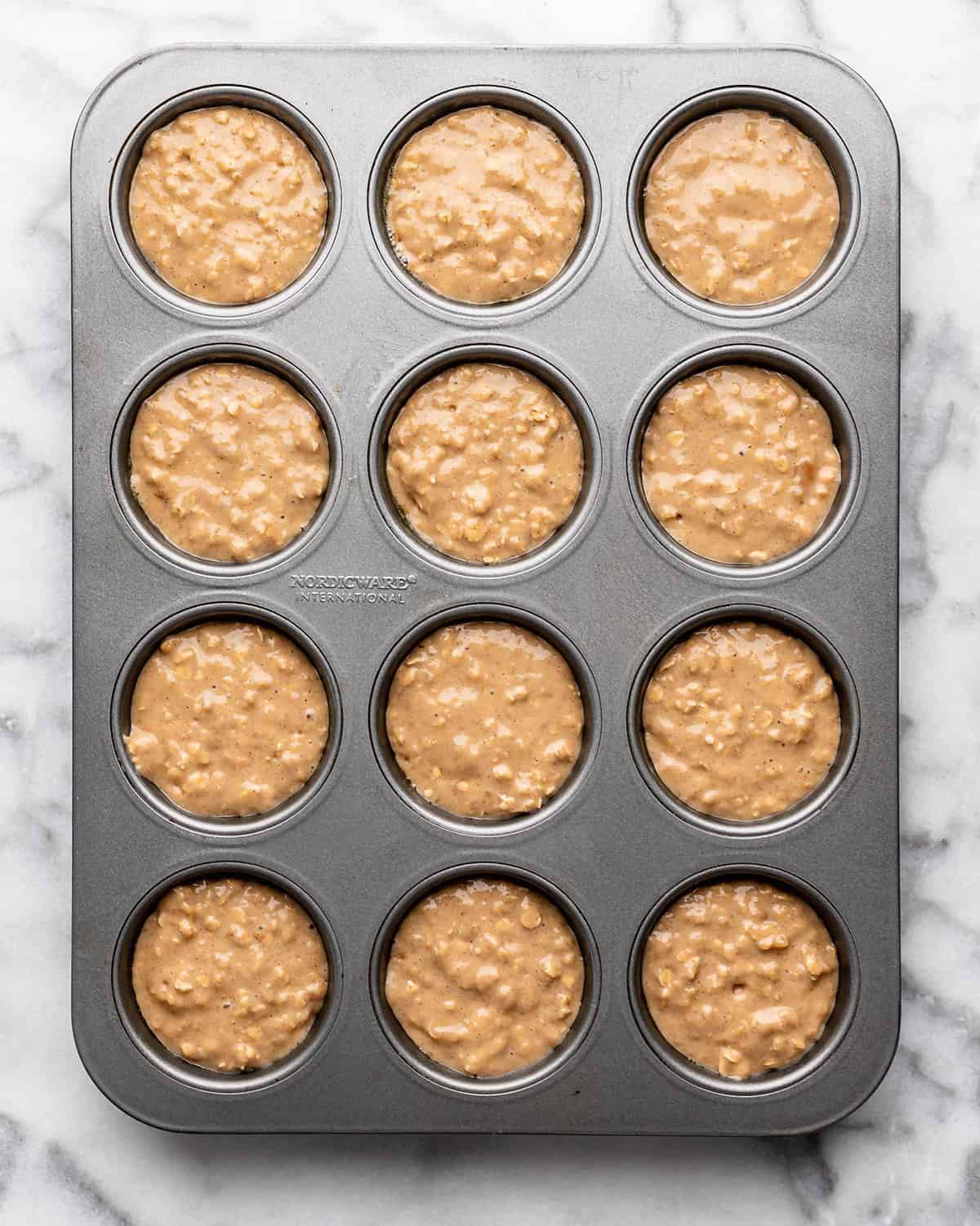 oatmeal muffins in a muffin tin before baking