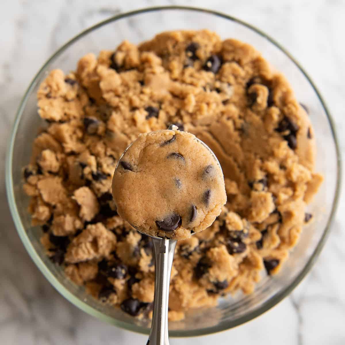 a cookie scoop portioning out Peanut Butter Chocolate Chip Cookie dough