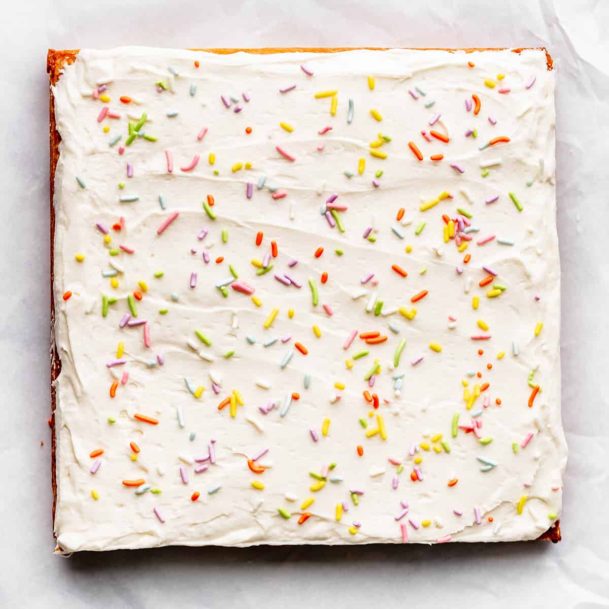 sugar cookie bars topped with sprinkles before being cut