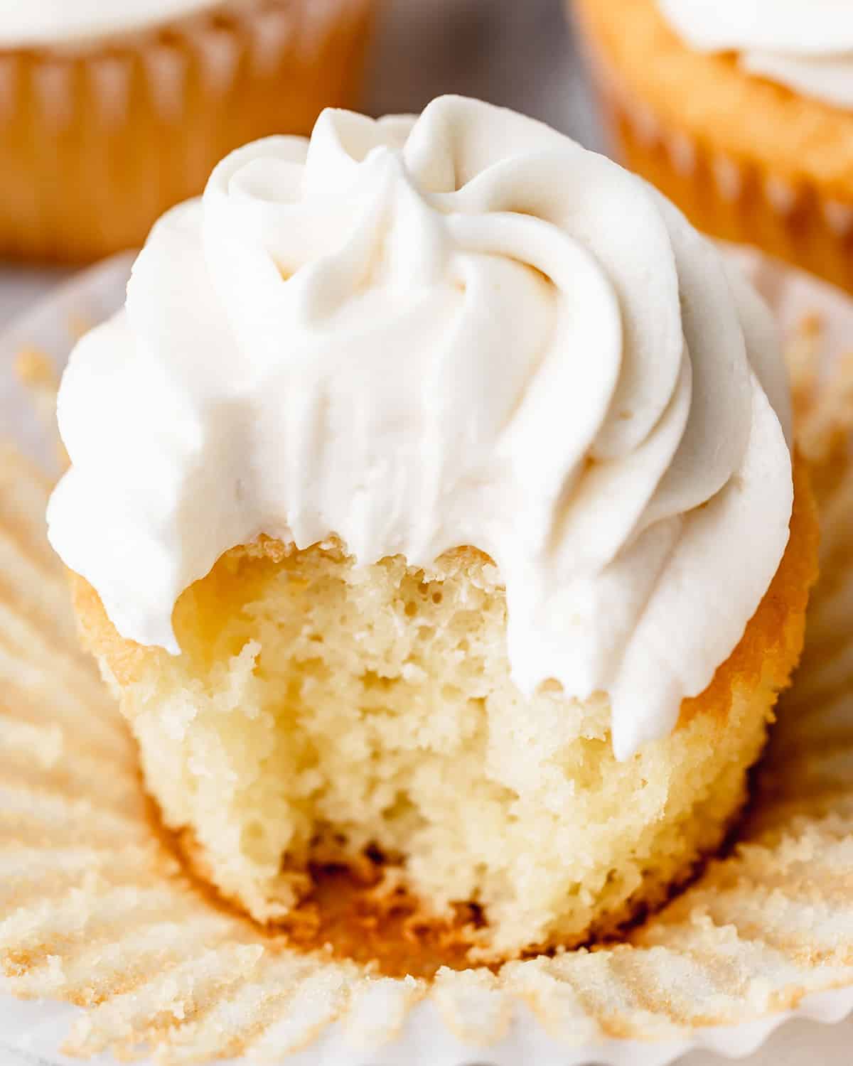 Vanilla Buttercream Frosting on a cupcake with a bite taken out of it