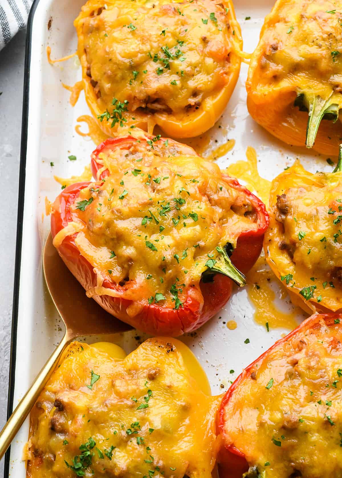 Stuffed Peppers after baking garnished with parsley on a baking sheet
