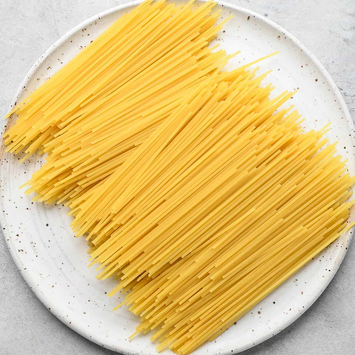 uncooked pasta noodles cut in half to make Chicken Tetrazzini