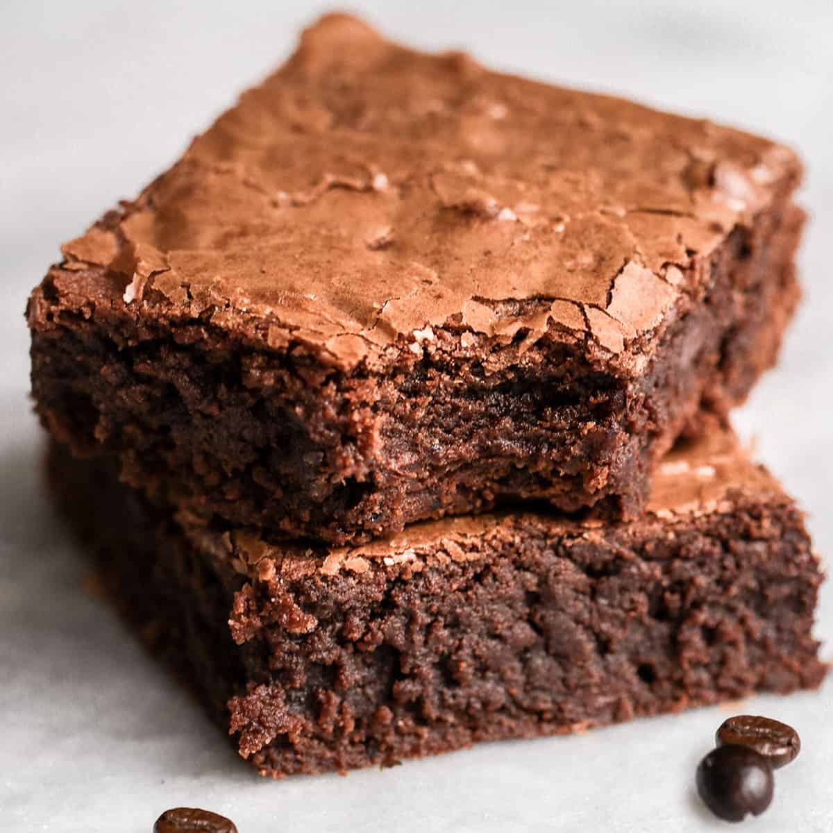 a stack of 2 Coffee Brownies, top one has a bite taken out of it