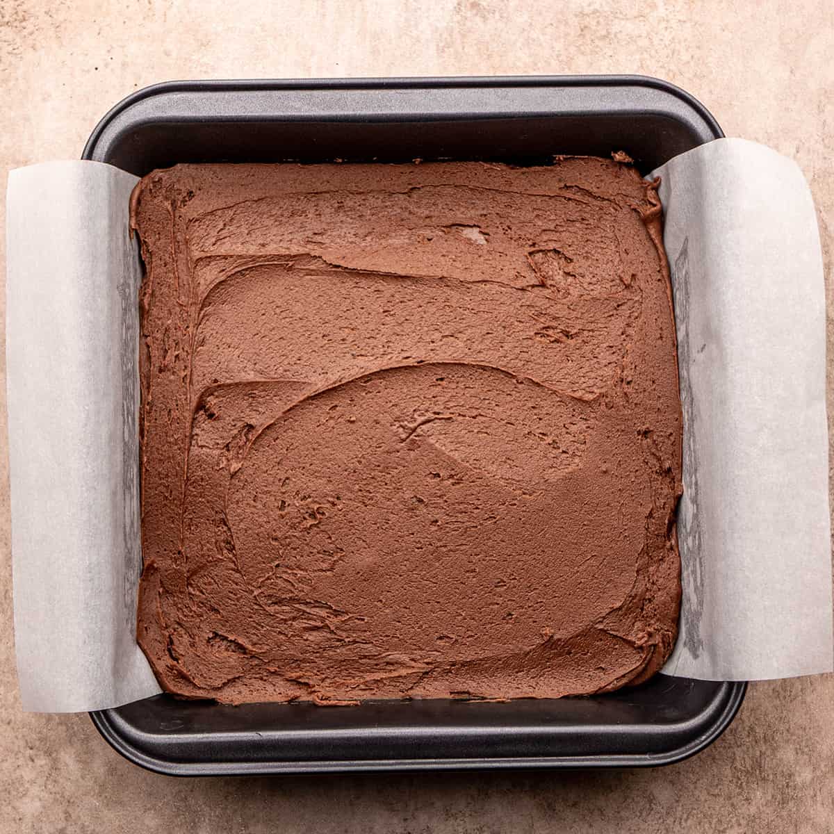 chocolate fudge mixture spread into prepared square pan