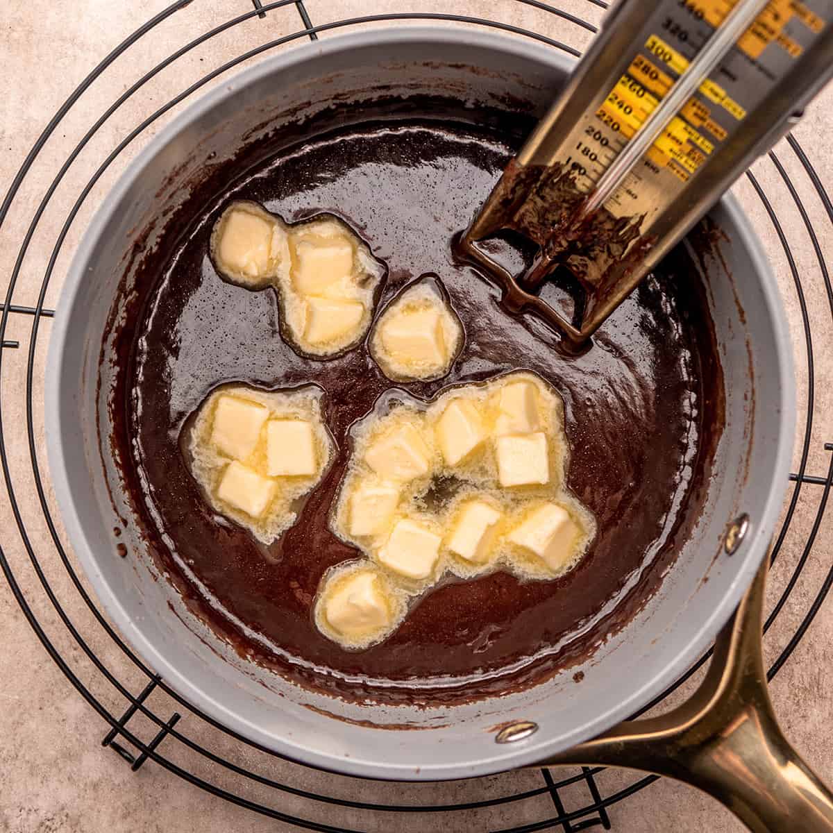 How to Make Chocolate Fudge - adding butter to fudge mixture