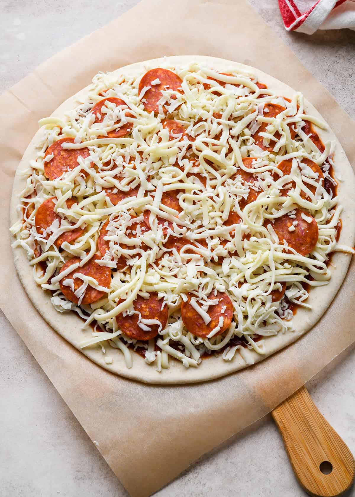 pepperoni pizza on a pizza peel before baking