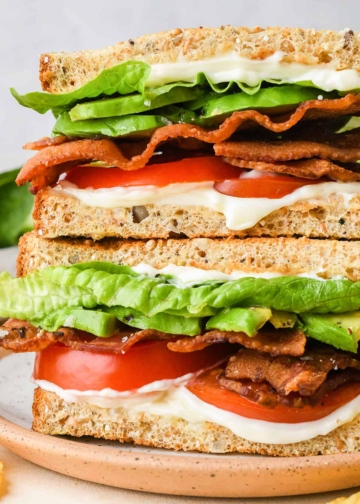 two halves of a BLT Sandwich stacked on a plate