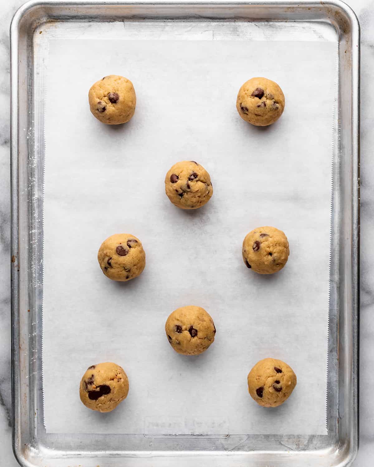 8 Toffee Cookies dough balls on a baking sheet before baking