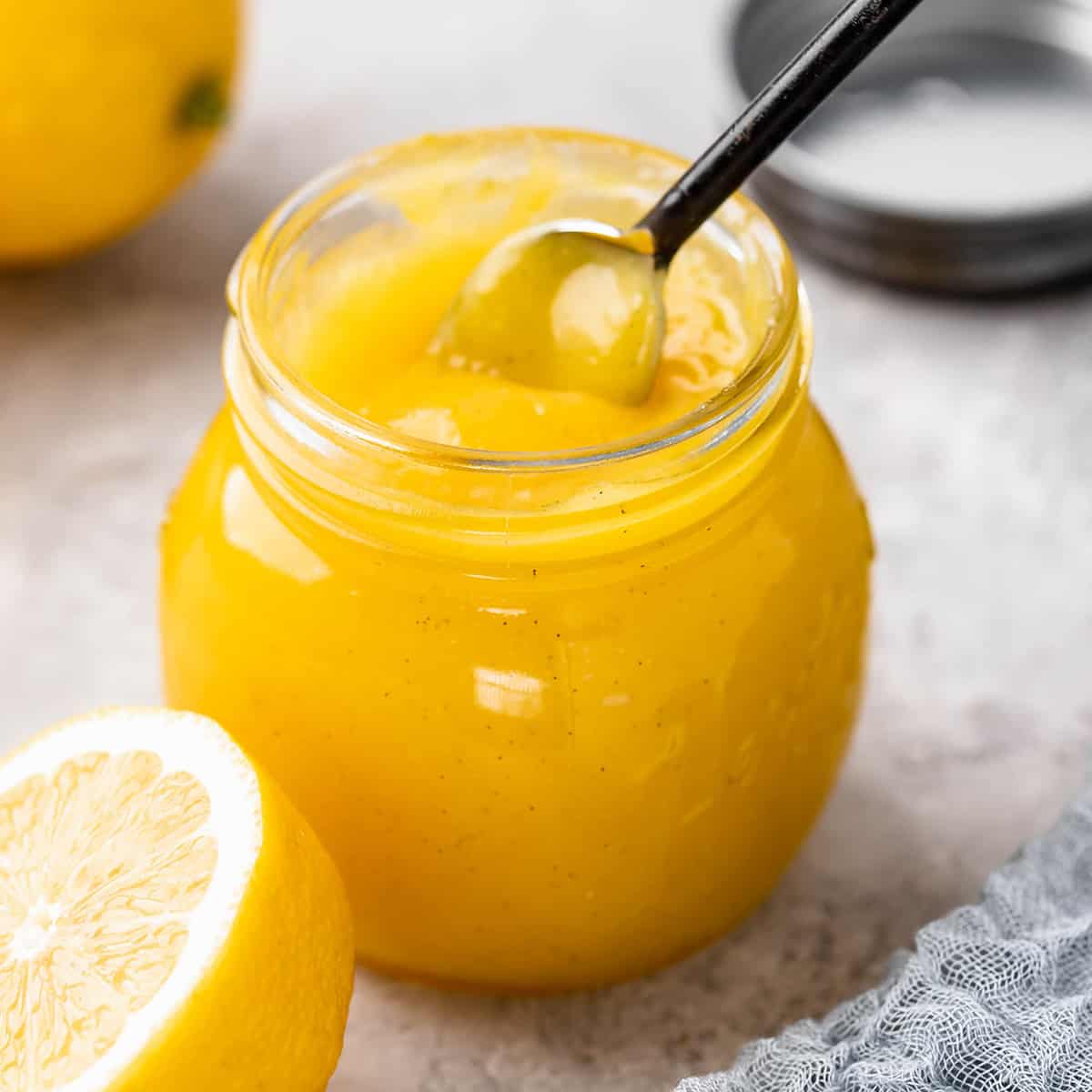 Lemon Curd in a jar with a spoon