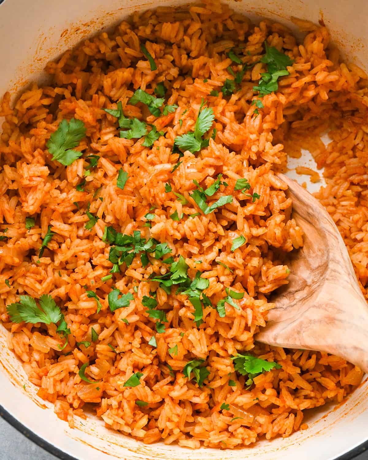 Mexican rice in a pot garnished with cilantro