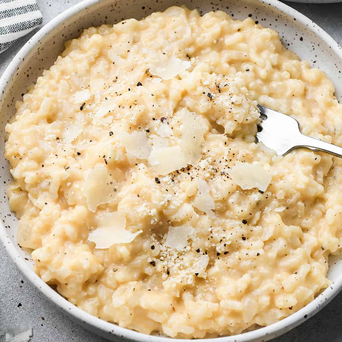 a bowl of this Easy Risotto Recipe with a fork