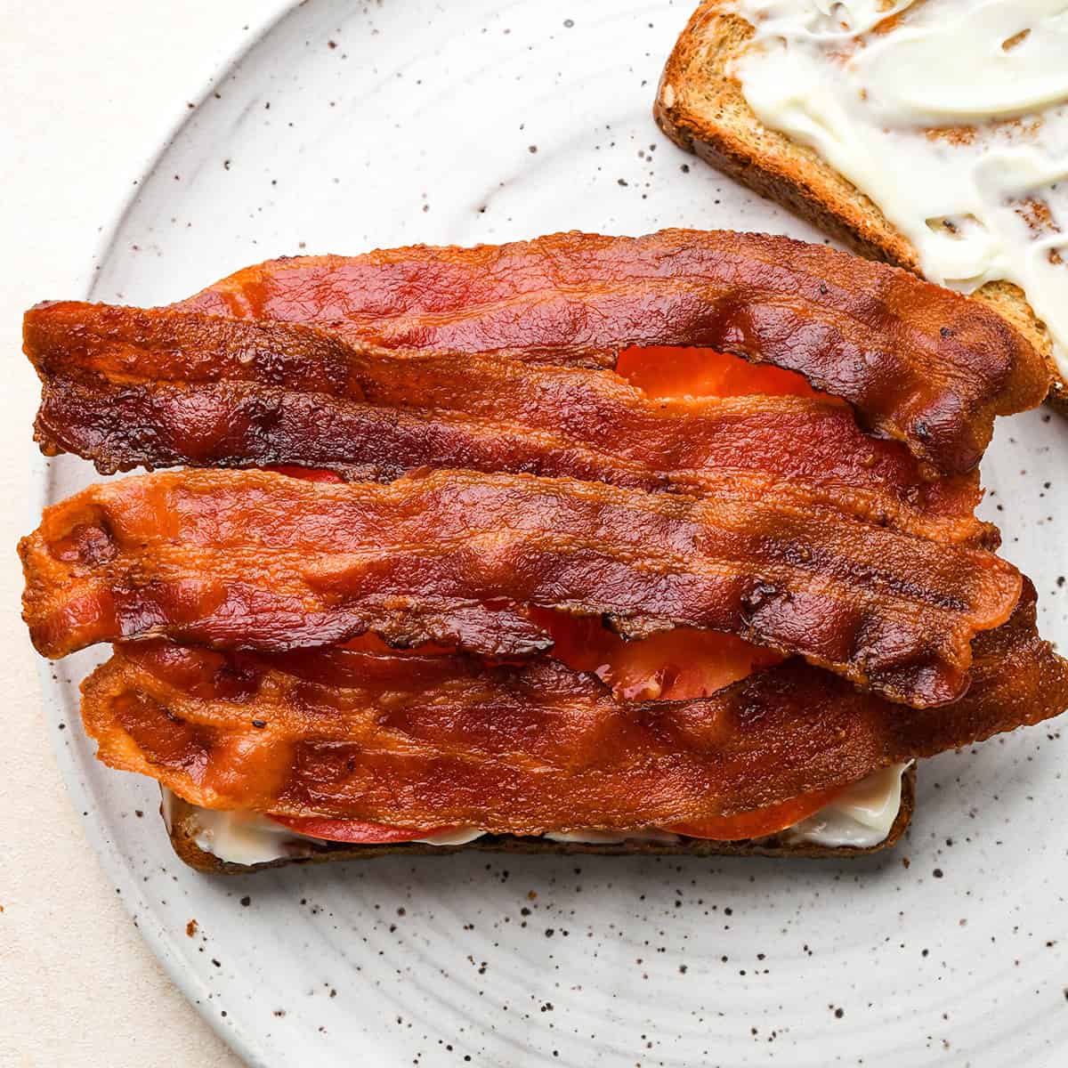 assembling a BLT sandwich - adding bacon