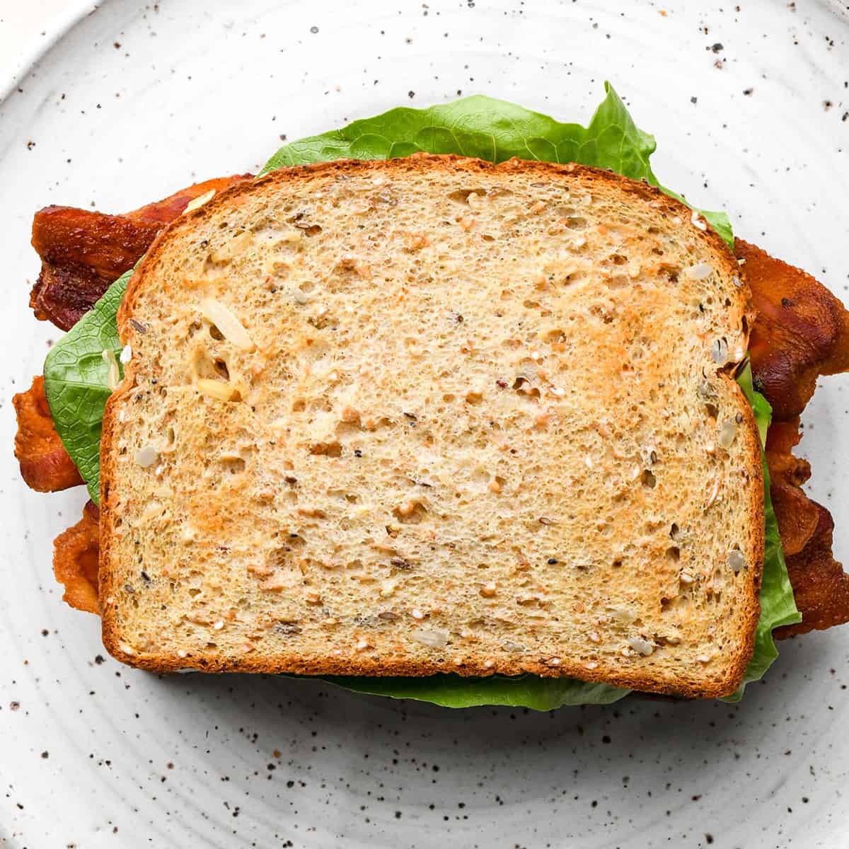 assembling a BLT sandwich - adding the top slice of bread
