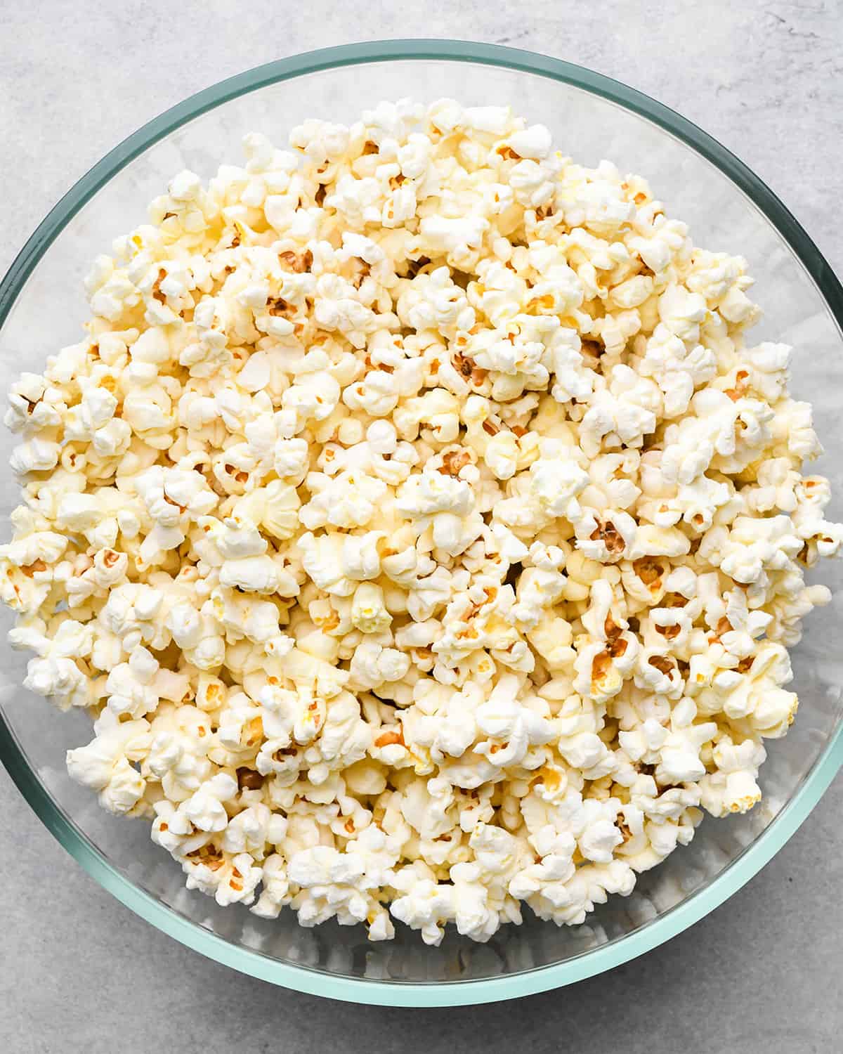 popped popcorn in a large glass bowl to make Butter Popcorn