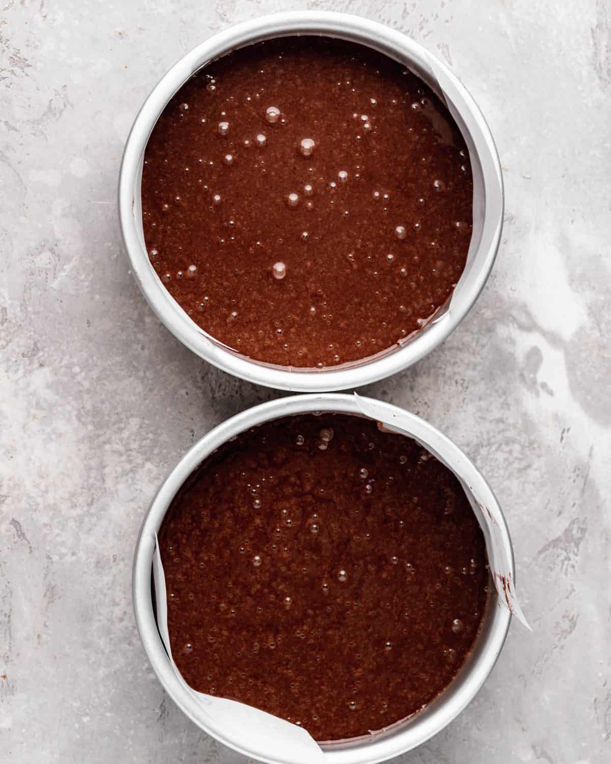 how to make chocolate cake from scratch - cake batter in two lined round 6" metal cake pans