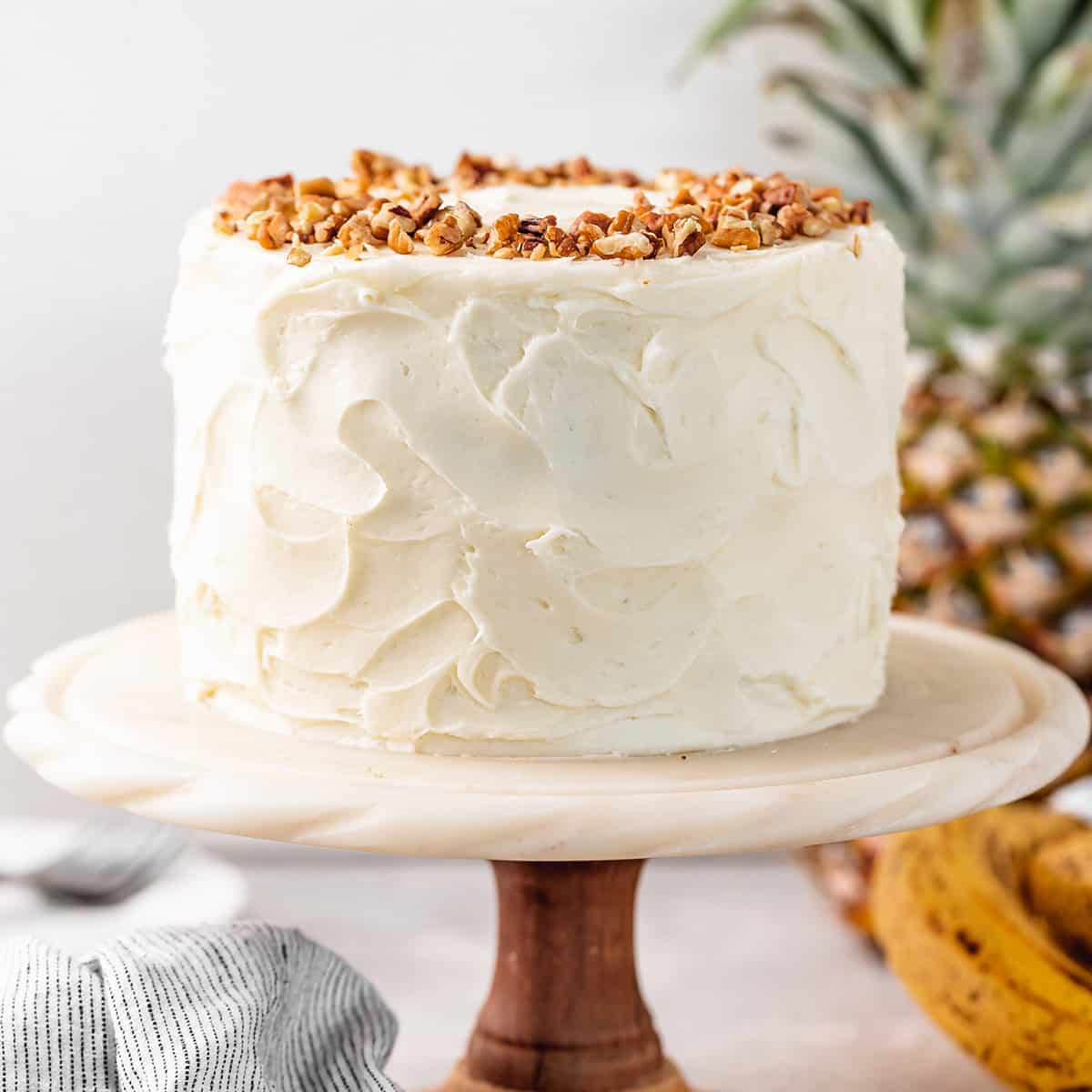 Hummingbird Cake frosted on a cake stand