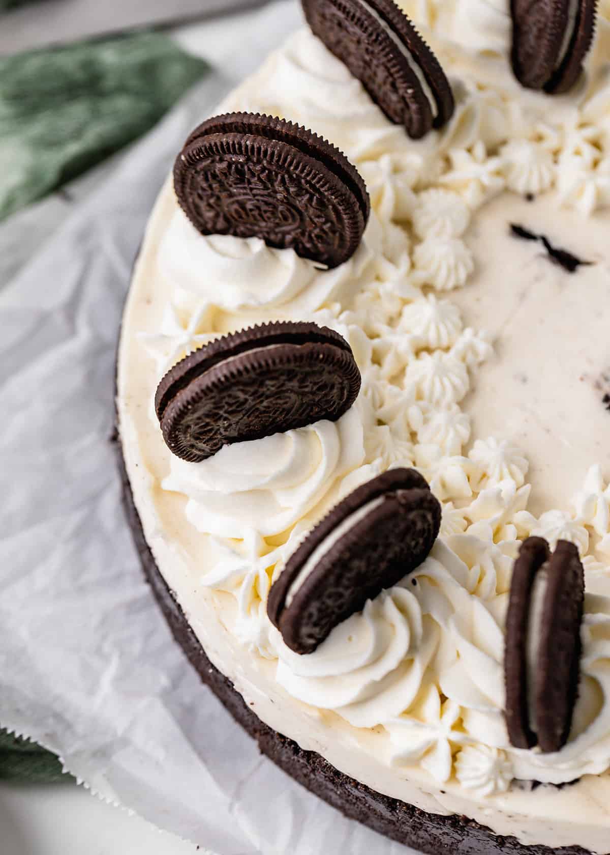 No Bake Oreo Cheesecake topped with whipped cream and oreos