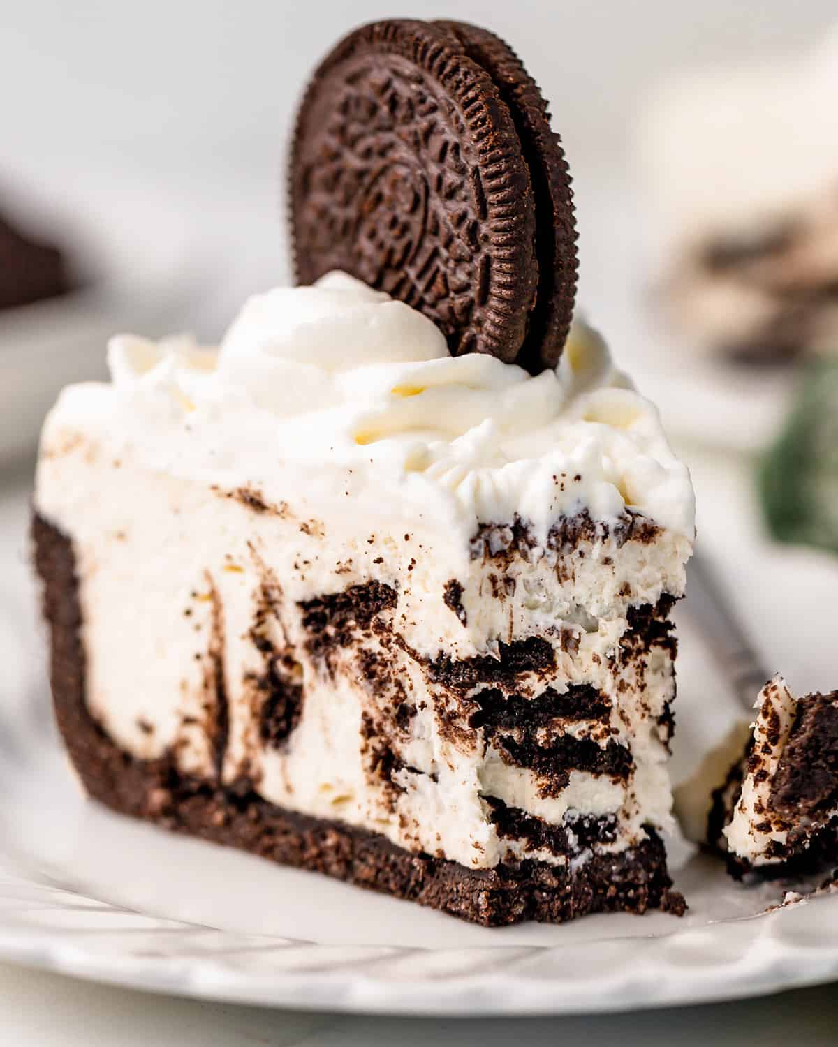 a slice of No Bake Oreo Cheesecake with a bite taken out of it