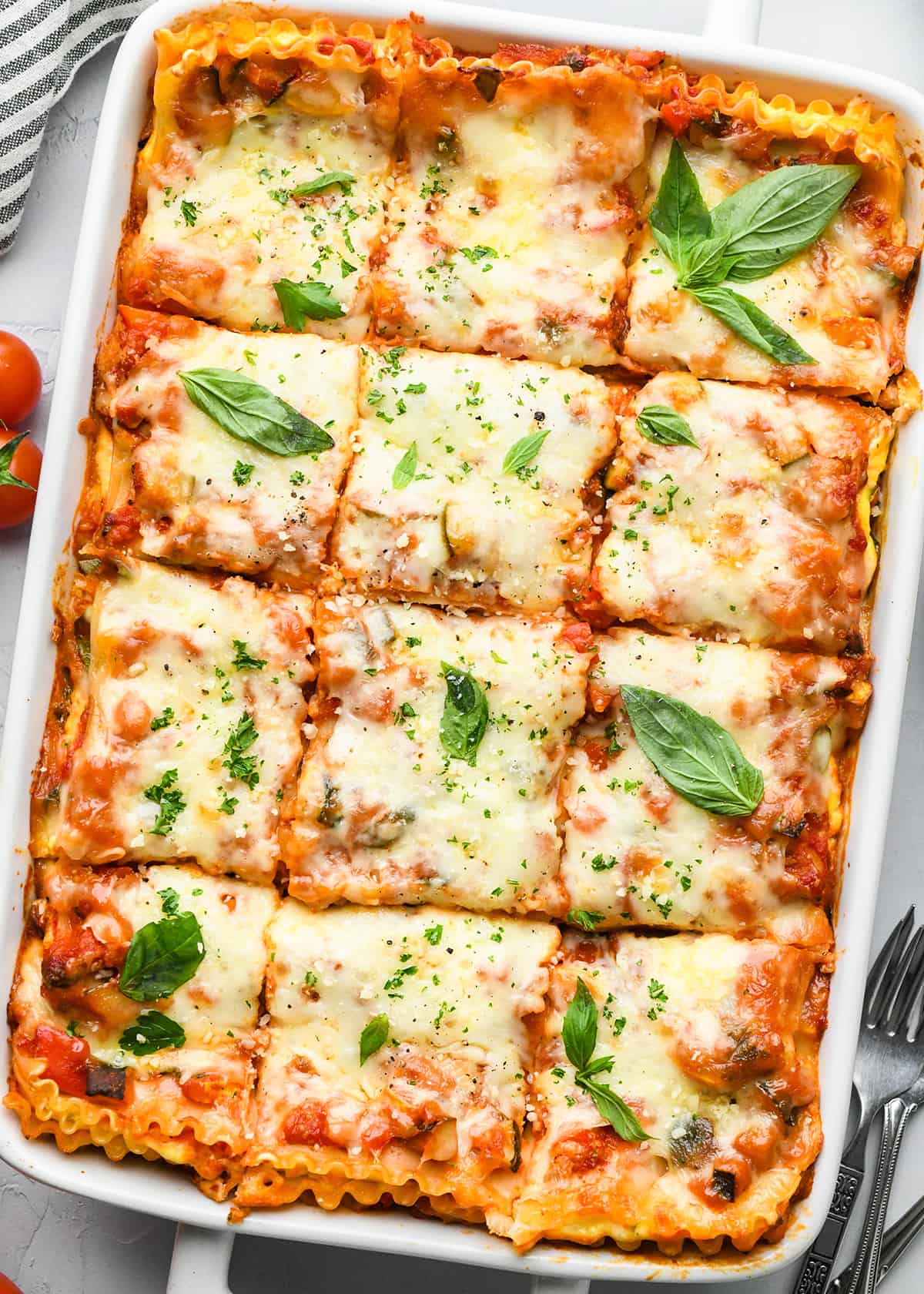 Vegetable Lasagna in a baking dish cut into 12 pieces