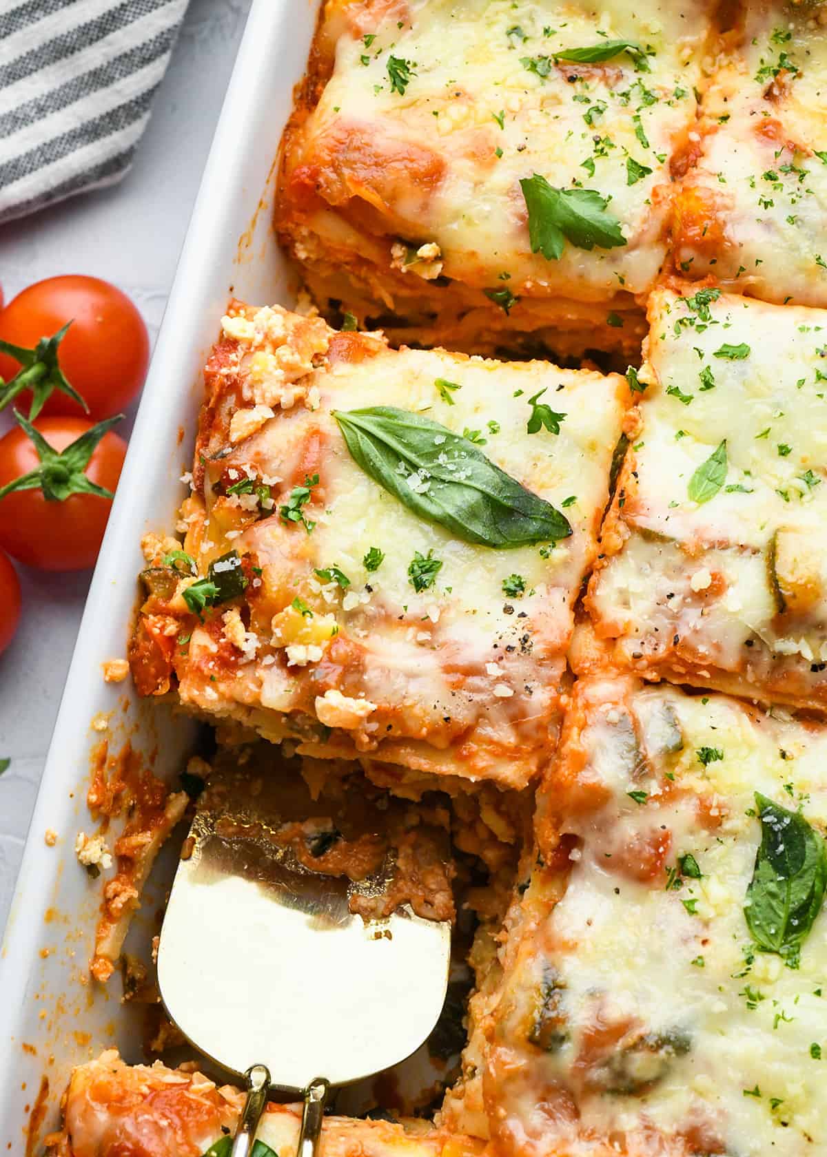 vegetarian lasagna in a baking dish cut into pieces