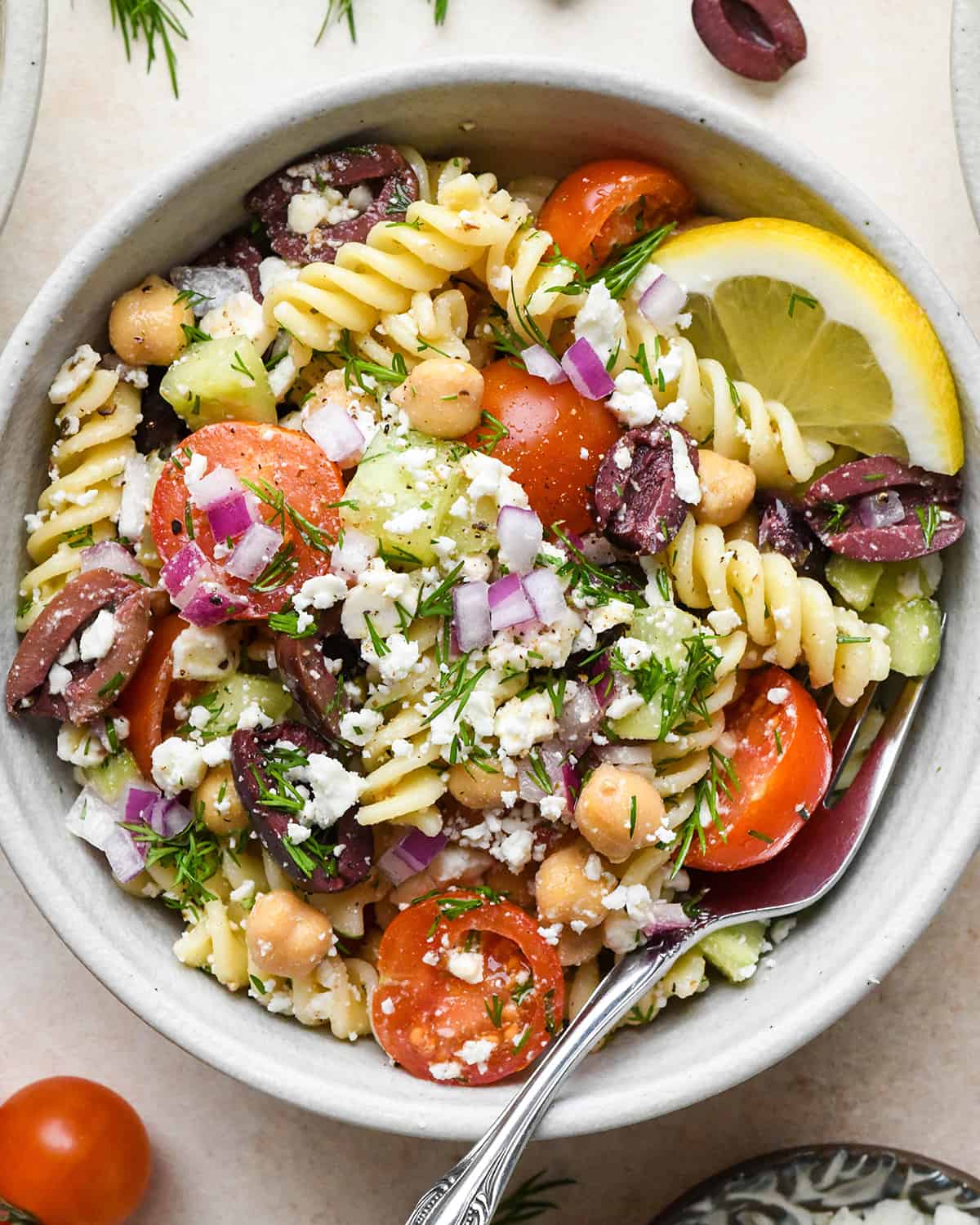Greek Pasta Salad in a small bowl with a fork