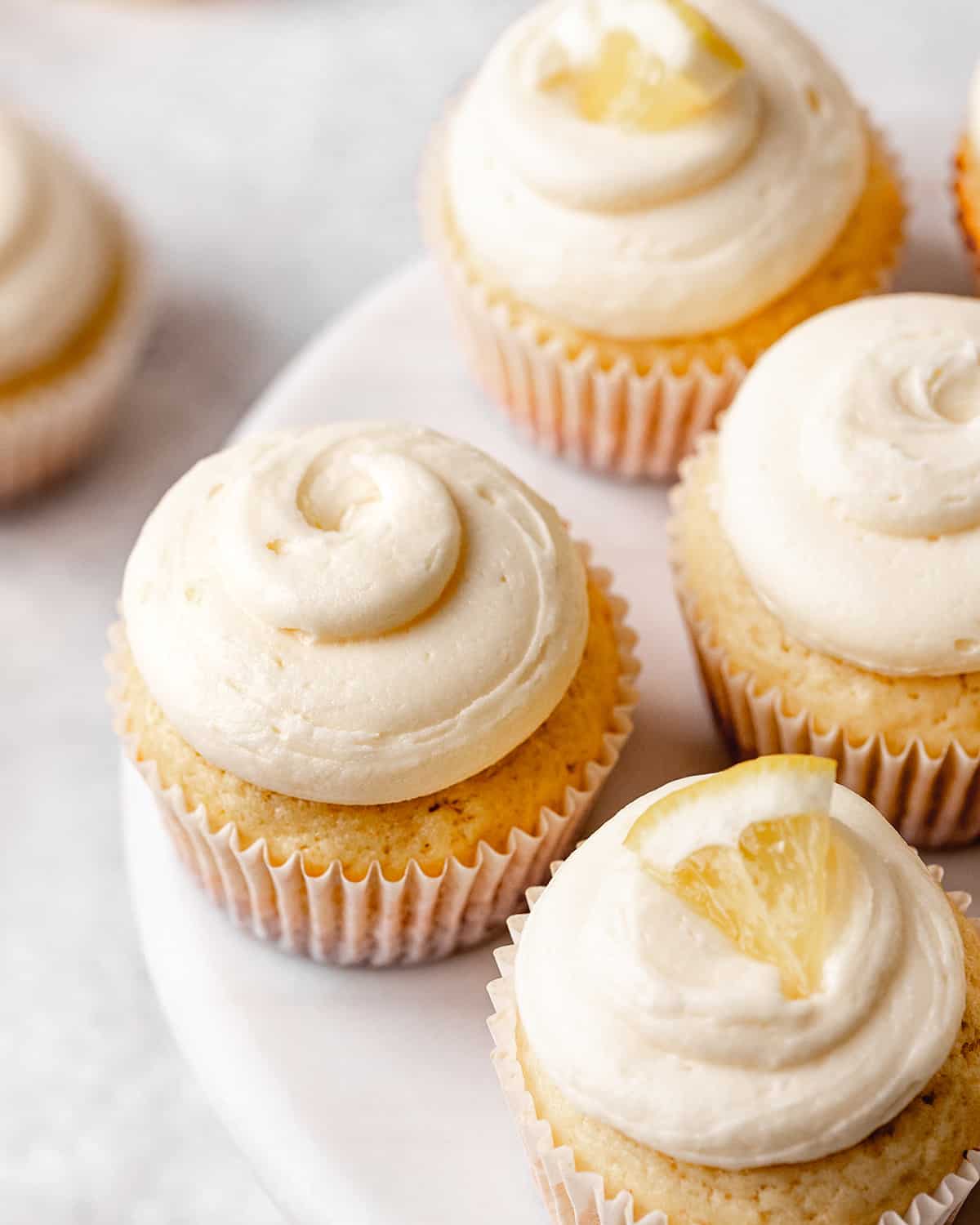 lemon buttercream frosting on top of 4 cupcakes