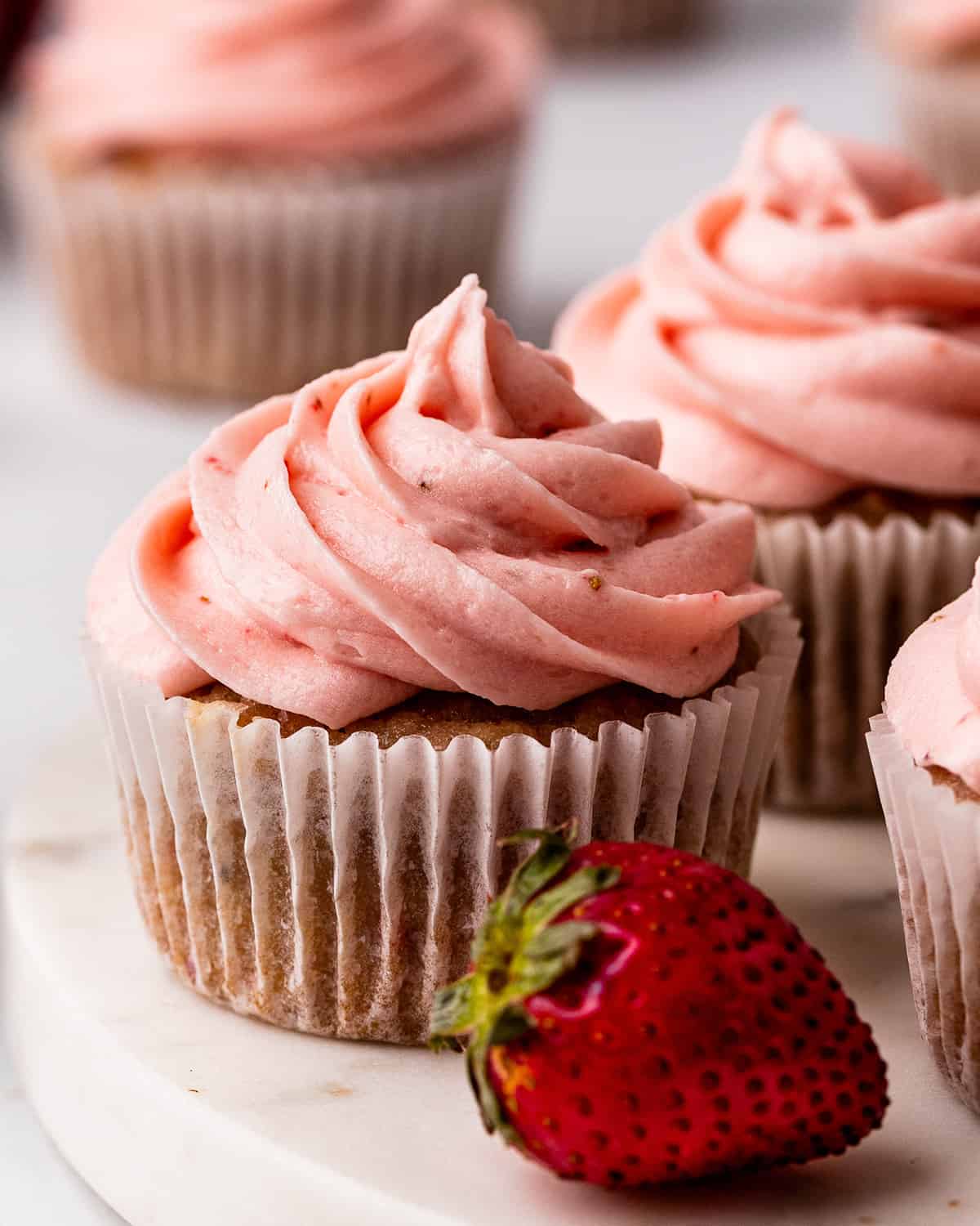 4 frosted Strawberry Cupcakes