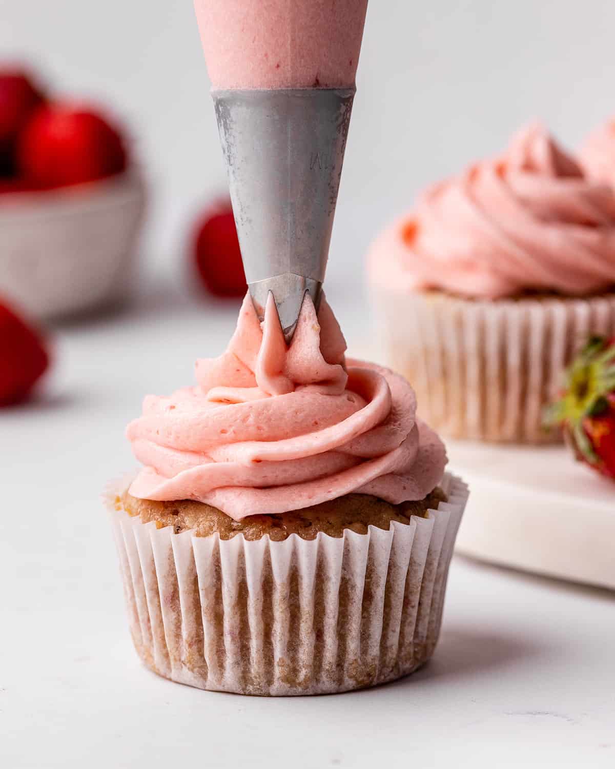 frosting being piped onto a Strawberry Cupcake